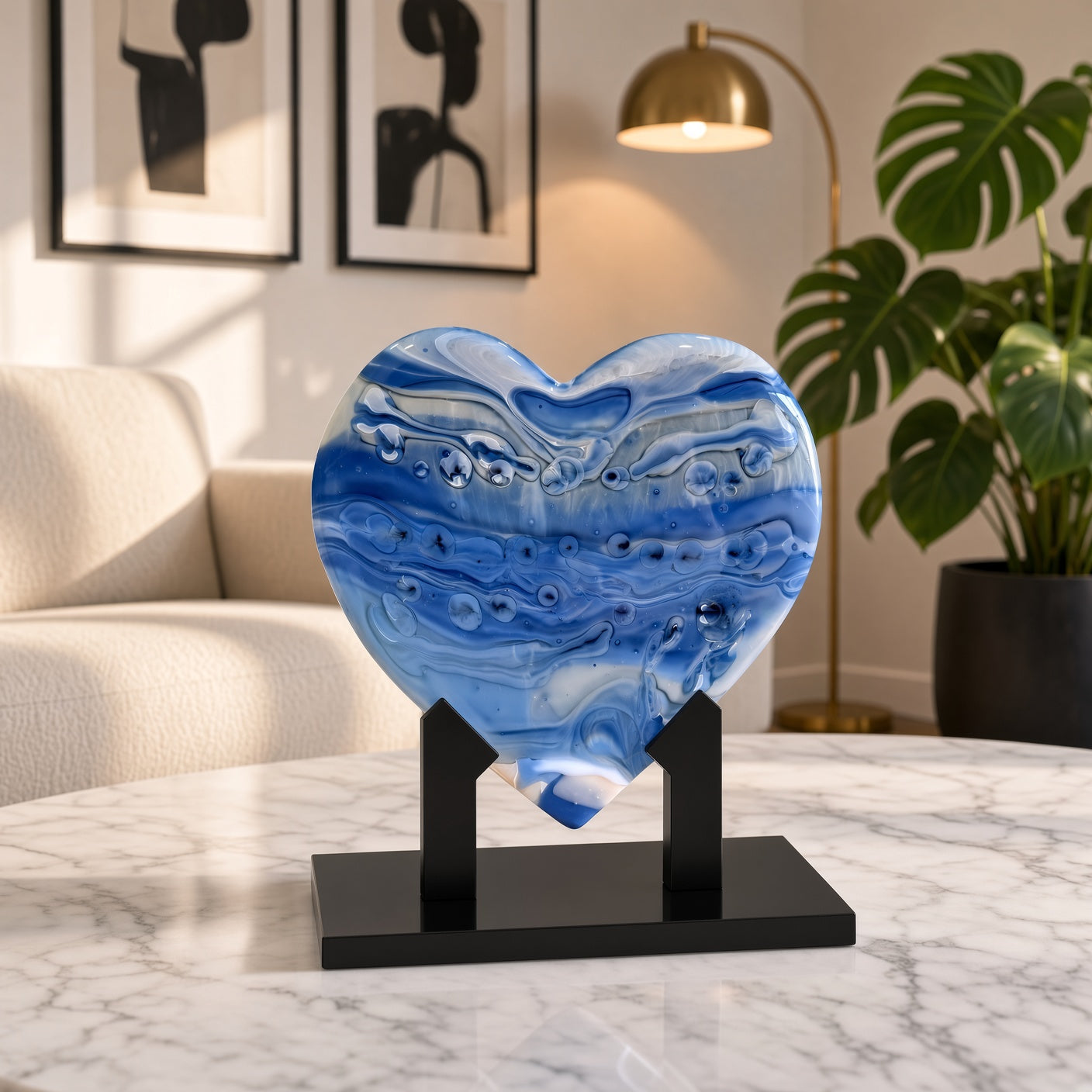 Periwinkle blue and white swirled glass heart sculpture on a black stand on a marble table - handmade fused art glass keepsake
