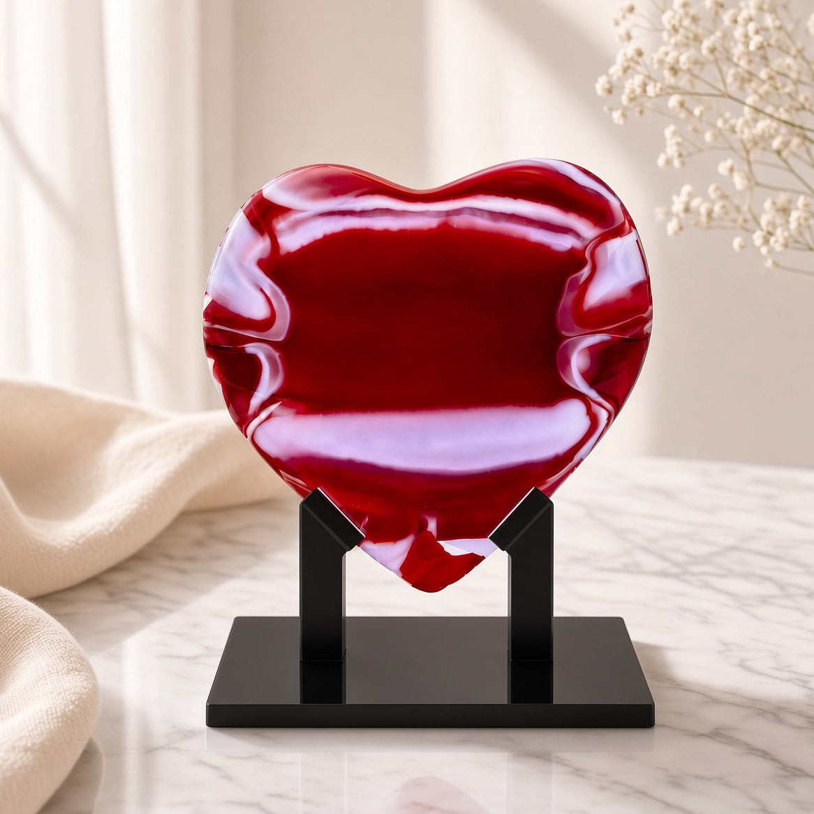 Red Glass Heart Sculpture displayed on a black stand on a marble surface - handmade fused art glass keepsake