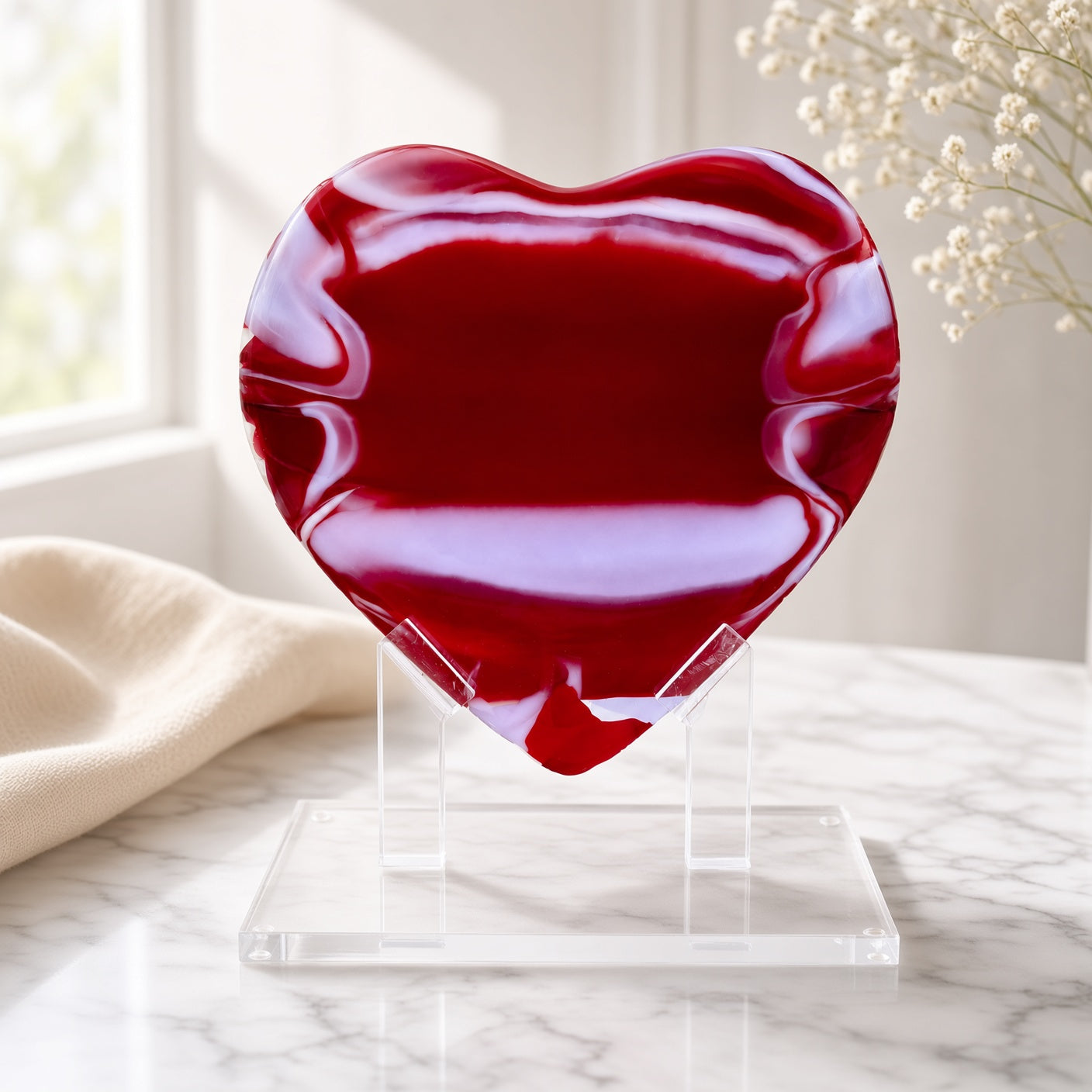 Red Glass Heart Sculpture on a clear acrylic stand on a marble surface - handmade fused art glass keepsake